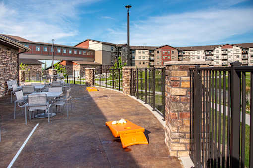 Outdoor Patio with Tables and Cornhole