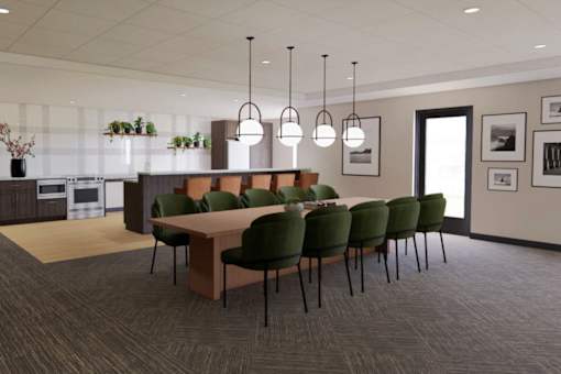 A conference room with a long table surrounded by green chairs.