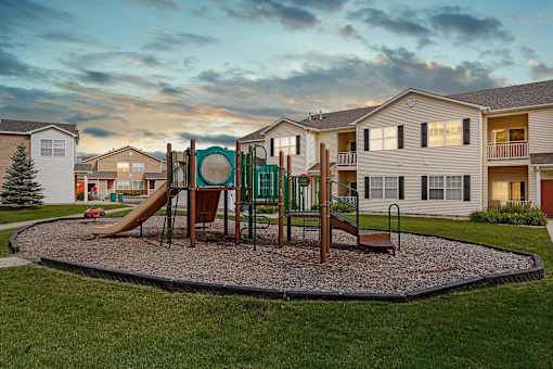 On site community playground against a sunset sky.