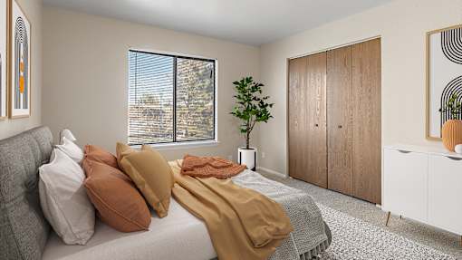 a bedroom with a bed with pillows and blankets on it