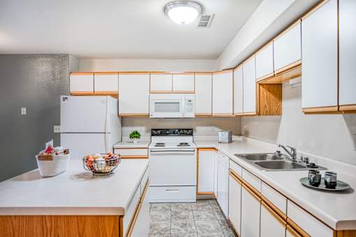 a kitchen with white appliances and wooden cabinets