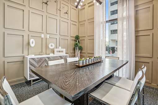 a dining room with a table and chairs and a window