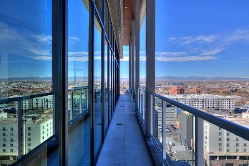 Sky lounge balcony, with concrete pillars and walkway and glass railing