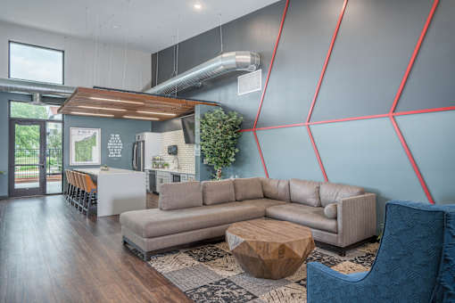 A modern living room with a grey sofa and a wooden coffee table.