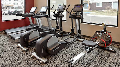 a group of exercise machines in a gym