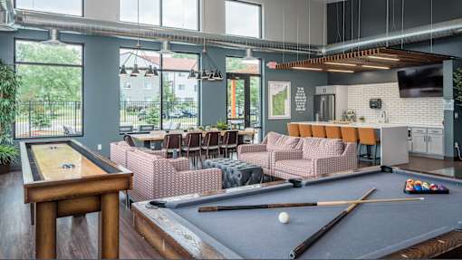 a common room with a pool table and a bar