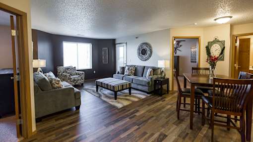 a living room and dining room with furniture and a table