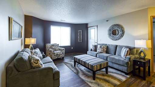 a living room with couches and chairs and a table
