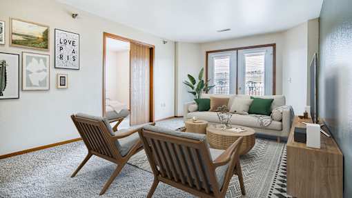 a living room with a couch and a table and two chairs