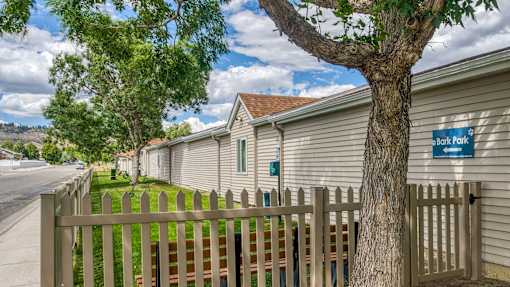 a row of houses with a fence and a tree