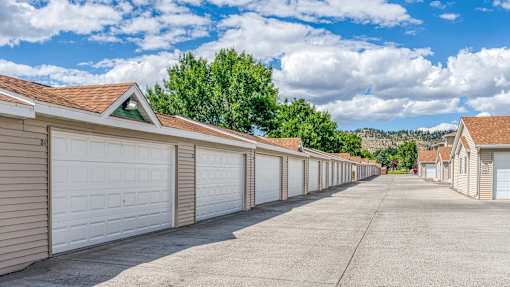 a long row of garages with white garage doors