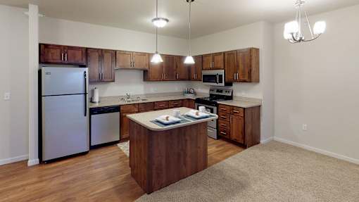 a kitchen with stainless steel appliances and wooden cabinets