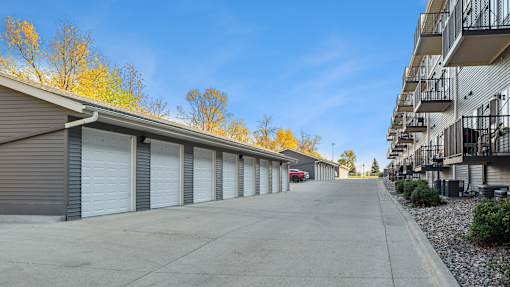 A row of garage doors in a parking lot.