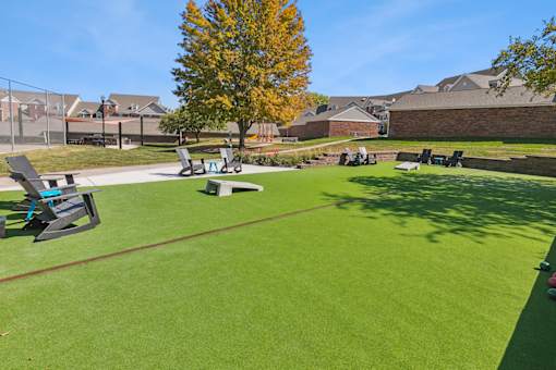 a park with picnic tables and benches on the grass