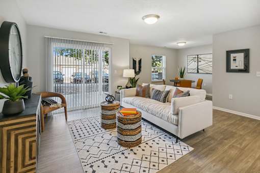 an open living room with a white couch and a rug