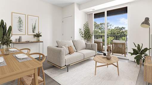 A living room with a grey couch, a wooden table, and a sliding glass door.