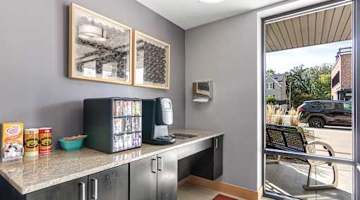 A kitchen with a counter and a fridge.