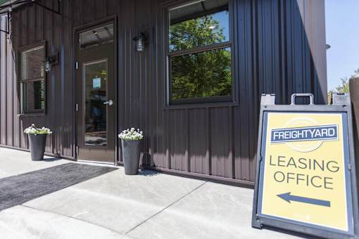 Exterior of FreightYard Leasing office with sign pointing to front door.