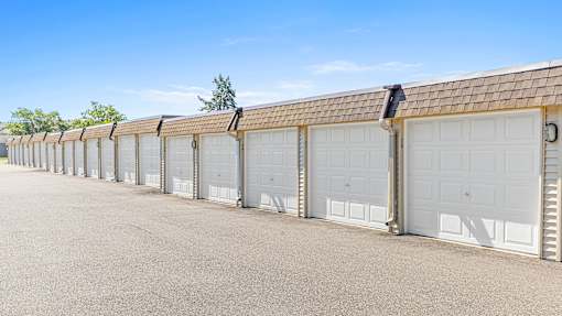 a row of garages with white garage doors