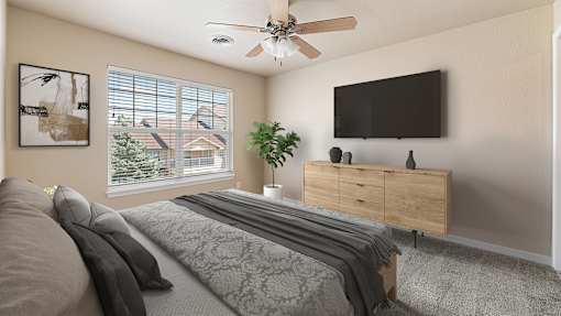 a bedroom with a bed and a ceiling fan