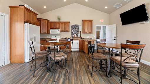 a kitchen and dining area with a table and chairs