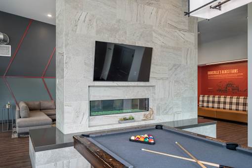 A pool table with a green cloth and a set of pool balls on it.