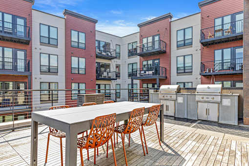 A table with chairs is on a balcony.