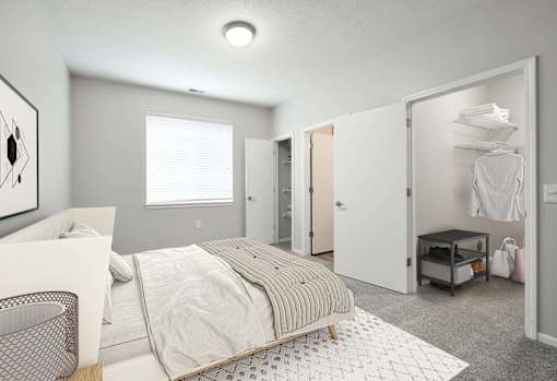 Spacious bedroom with a large window and plenty of space in the walk in closet.