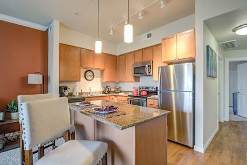 a kitchen with an island and stainless steel appliances