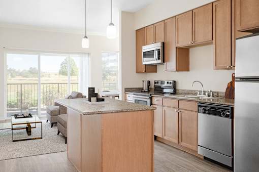 a kitchen with wooden cabinets and stainless steel appliances