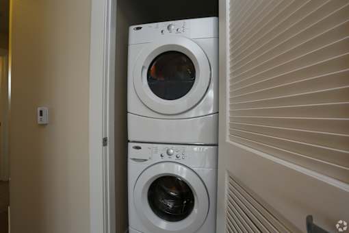 a front loading washer and dryer in a laundry room