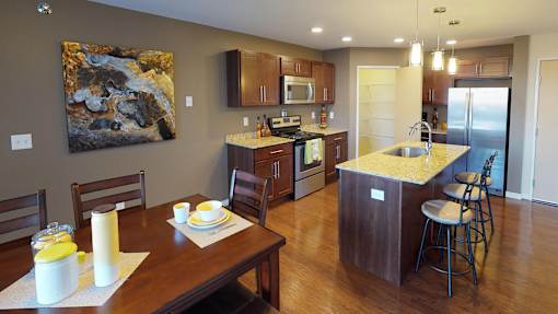a kitchen and dining room with a wooden table