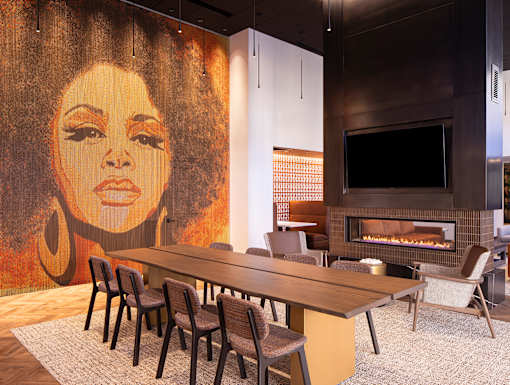 a conference room with a large painting of a woman on the wall