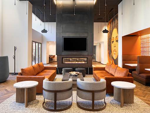 a large living room with a fireplace and a large painting on the wall