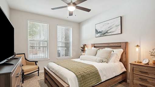 a bedroom with a large bed and a ceiling fan