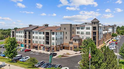 an aerial view of an apartment complex with a parking lot