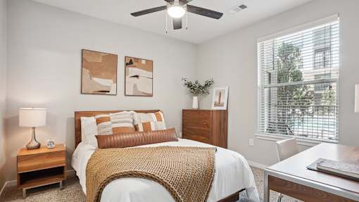 a bedroom with a bed and a ceiling fan
