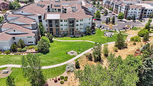 an aerial view of an apartment complex with a green park