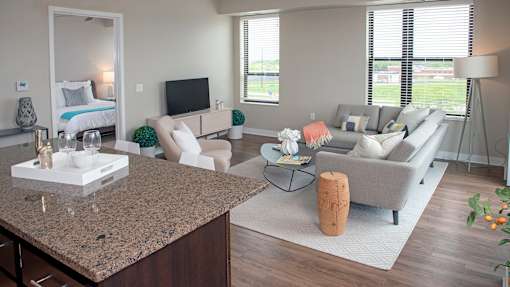 a living room with couches and chairs and a table
