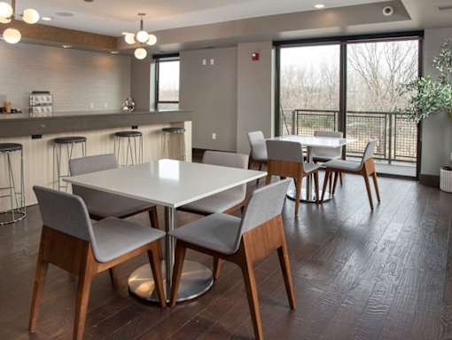 Community kitchen with bar, two square tables with chairs
