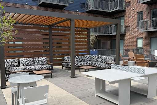 A patio with a white table and chairs.