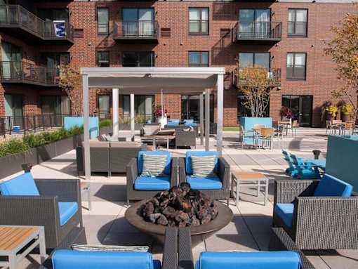Outdoor fire pit with surrounding lounge furniture