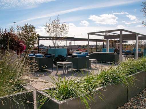Outdoor community patio with potted plants and lounge furniture
