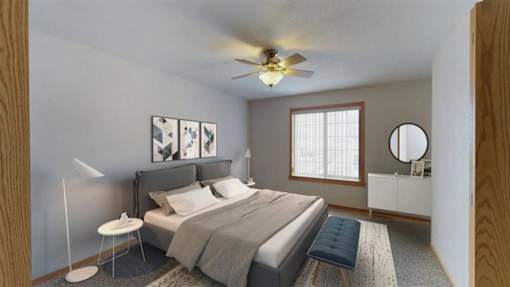 Spacious bedroom with a large window letting in natural light.