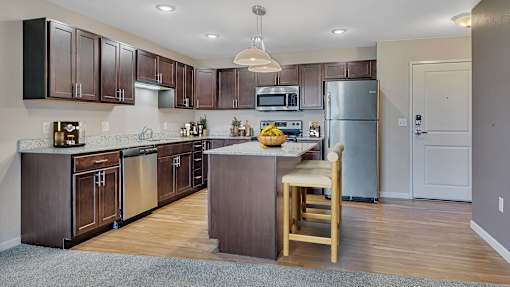 a kitchen with stainless steel appliances and wooden cabinets