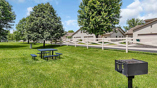 our yard has a picnic table and a grill and a fence