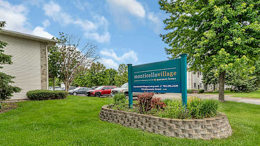 a sign sits in the grass in front of a building