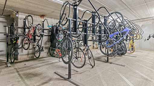 a row of bikes hanging on a rack in a building