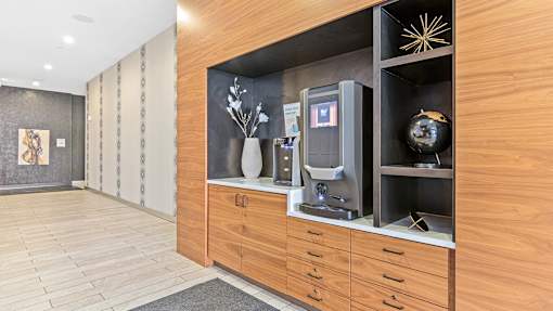 a lobby with a wood paneled wall with a coffee machine