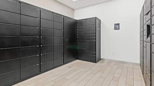 a row of black lockers in a white room